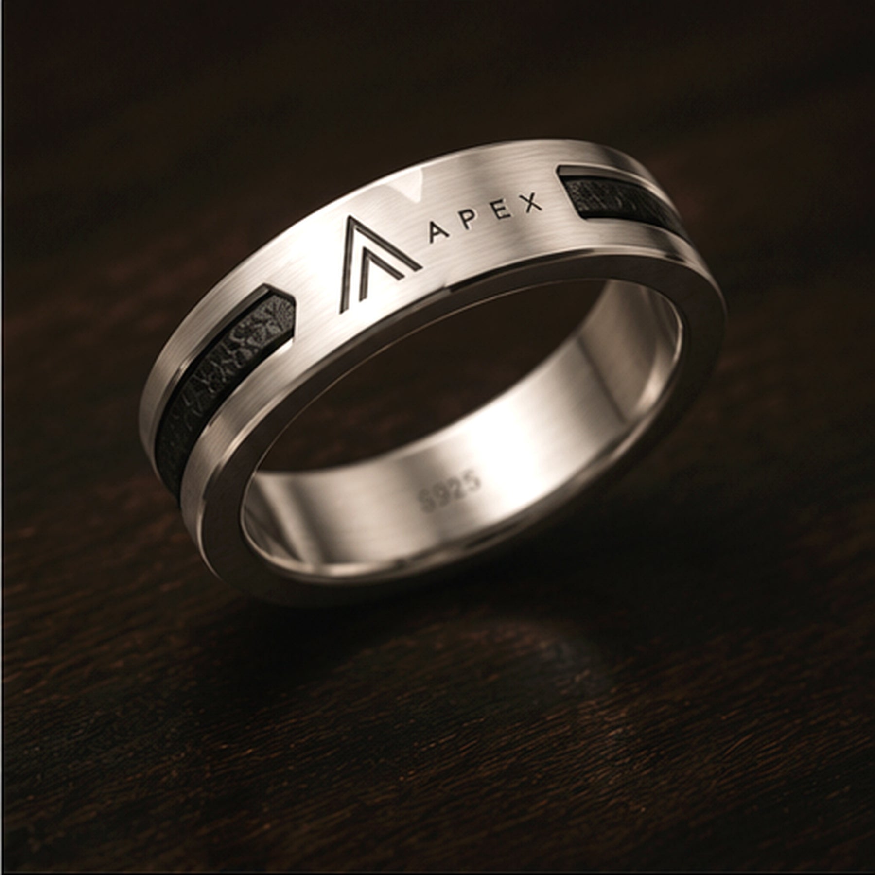 APEX Meridian ring on dark wood, warm light